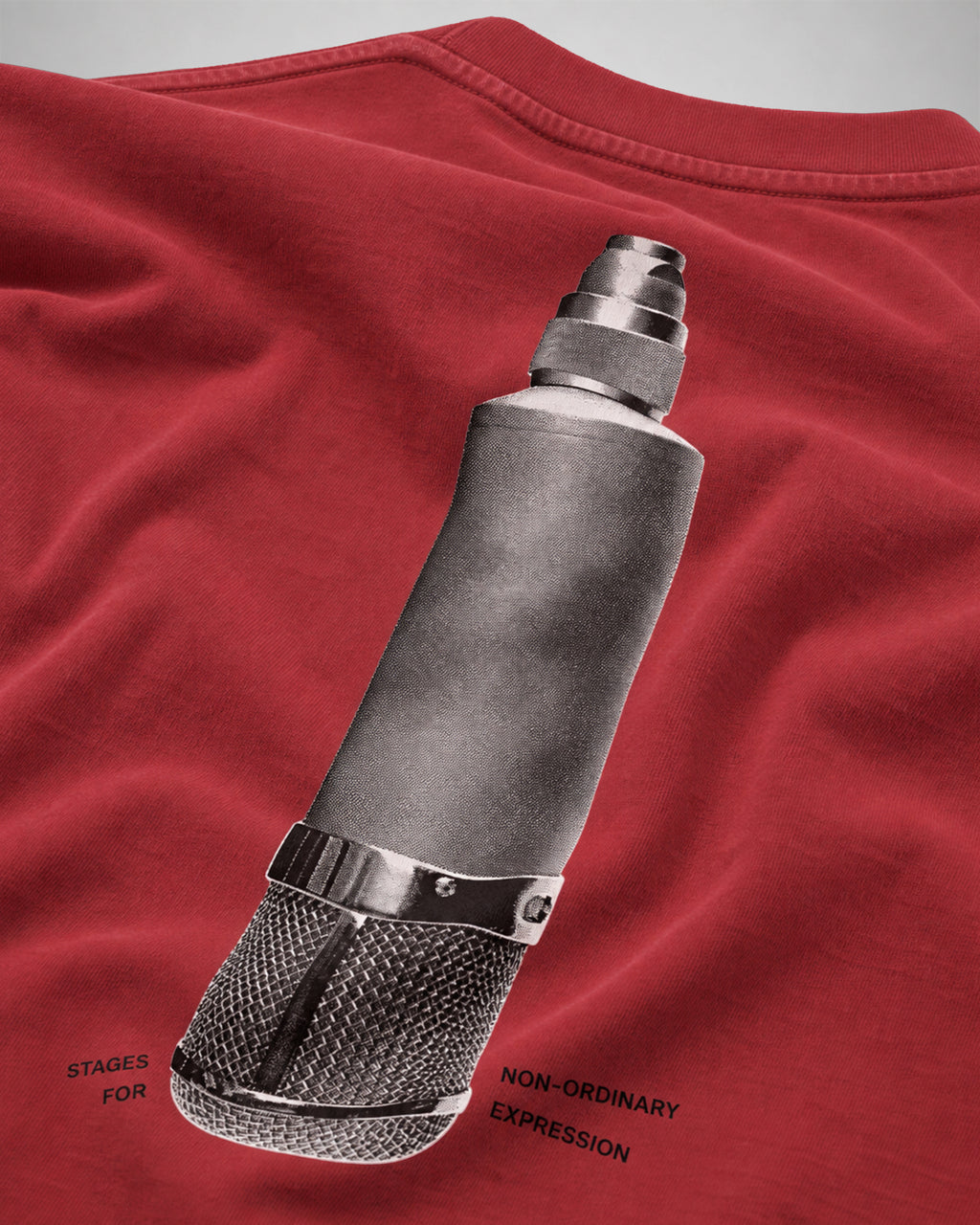 Close-up of the halftone microphone screen print on the back of the red COLORS Mic T-Shirt
