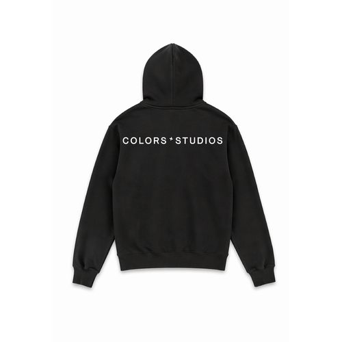 Black hoodie with hood and large white “COLORS * STUDIOS” logo print on the back.