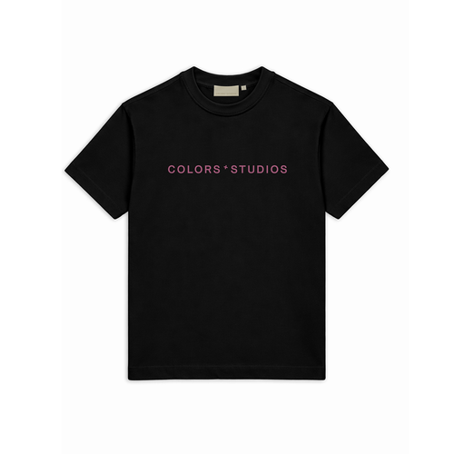 Black T-shirt with crew neck and centered pink “COLORS * STUDIOS” logo on the front.